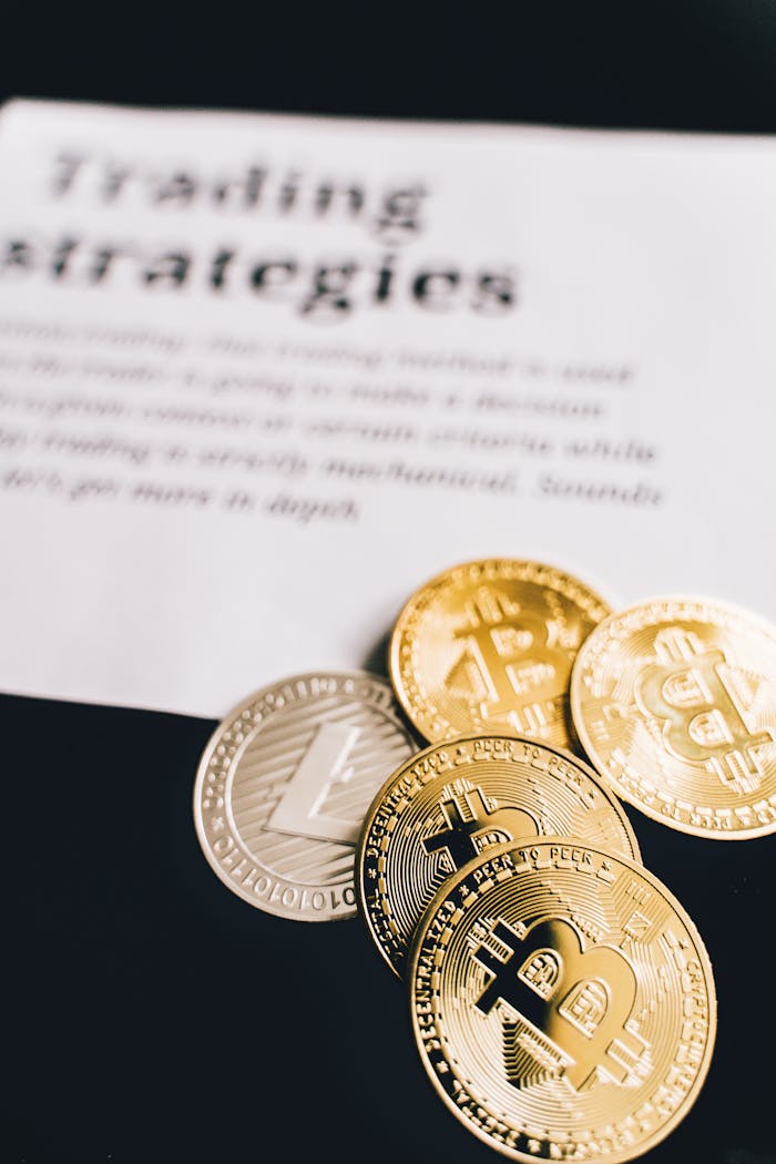 gallery-3 Close-up of Bitcoin and Litecoin coins on a trading strategies document.